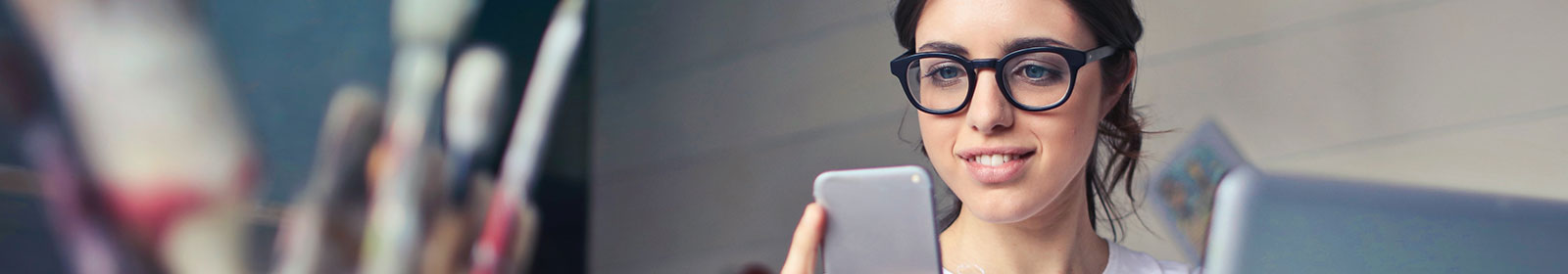 Young lady using a smartphone in her studio business
