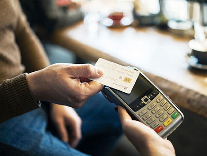 Man using a credit or debit card in a restaurant