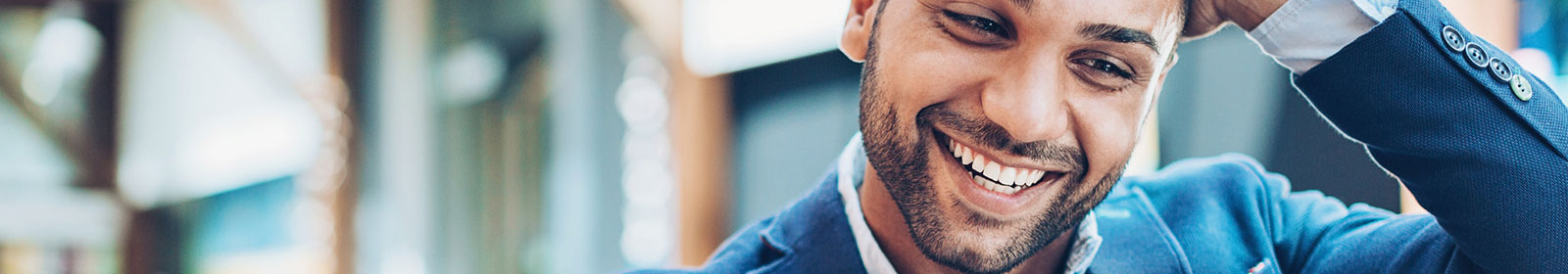 A business man smiling at good business news