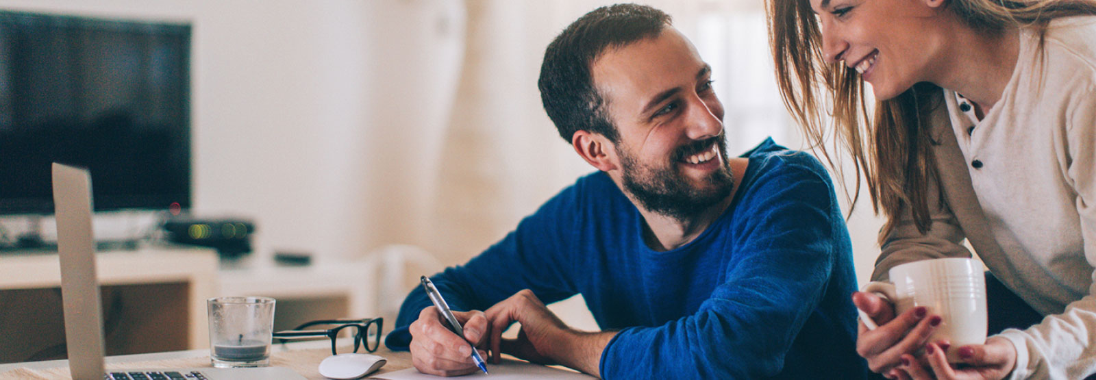 Young couple looking at financials in their home